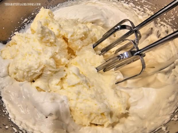 Cream cheese mixture is beaten into the whipped topping using an electric mixer.