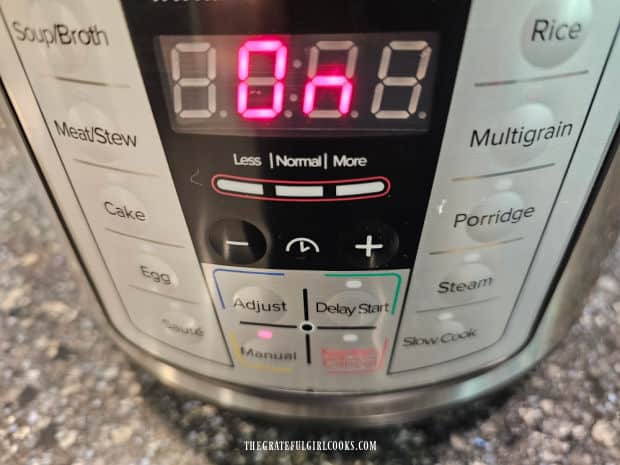 Instant Pot is set to Manual to cook the cheesy chicken rice casserole for 6 minutes.