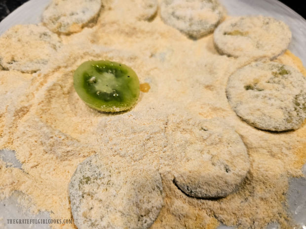 Egg-covered tomato slices are then dredged in flour/cornmeal mixture until fully coated.