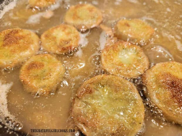 The fried green tomatoes are cooked until golden brown and crispy on both sides.
