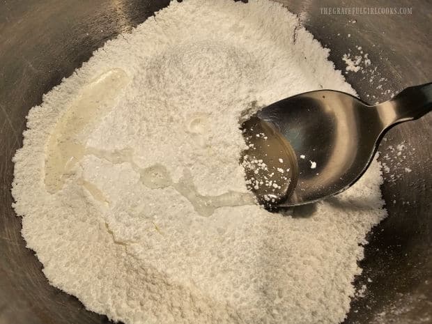 Corn syrup, vanilla extract and water is added to the powdered sugar.
