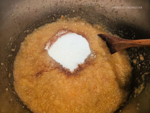 Granulated sugar, cinnamon and nutmeg are added to the applesauce.