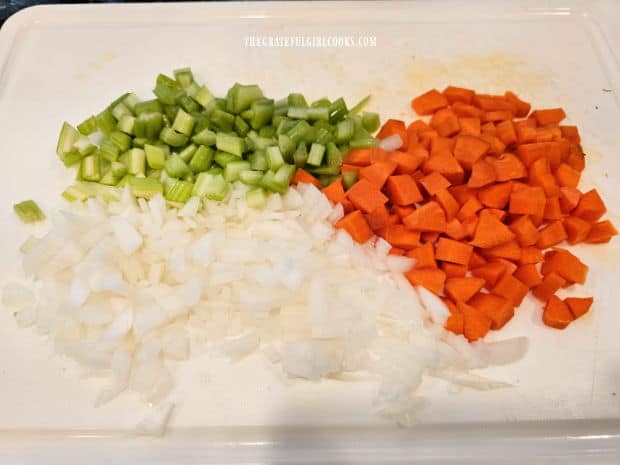 Onions, celery and carrots are diced into small pieces before cooking.