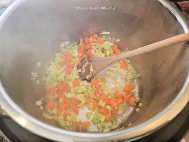 The onions, celery and carrots are sautéed in olive oil in the Instant Pot.