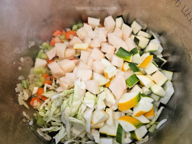 Potatoes, zucchini and cabbage are added to the Instant Pot.