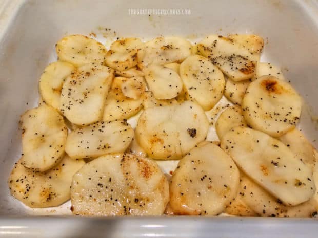 Potatoes are roasted in baking dish and flipped over, halfway through the baking time.