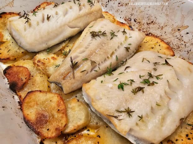 Baked cod and potatoes are cooked through and ready to be served.