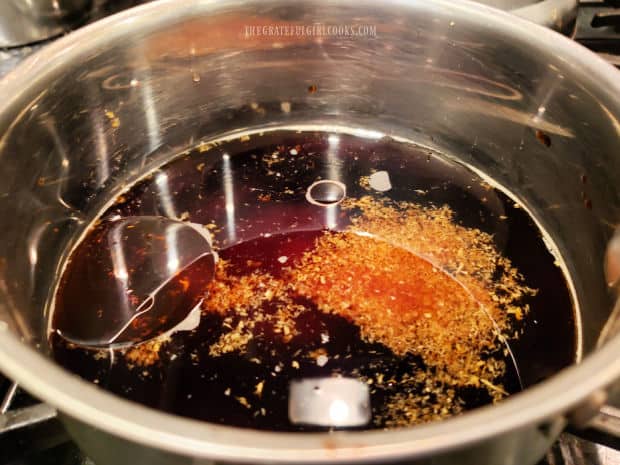Asian sauce for the stir fry is heated in a small saucepan.