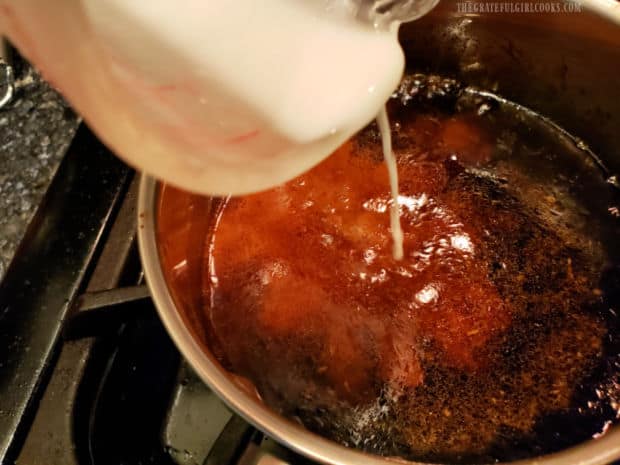 A corn starch and water slurry is added to the sauce to thicken it.