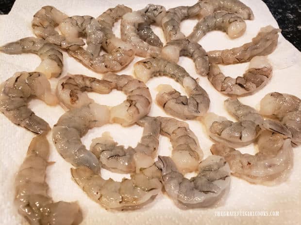 Shrimp is deveined, tails are removed and then shrimp is patted dry.