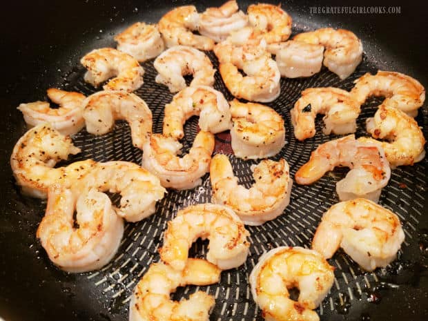 The shrimp are quickly pan-seared in oil until done.