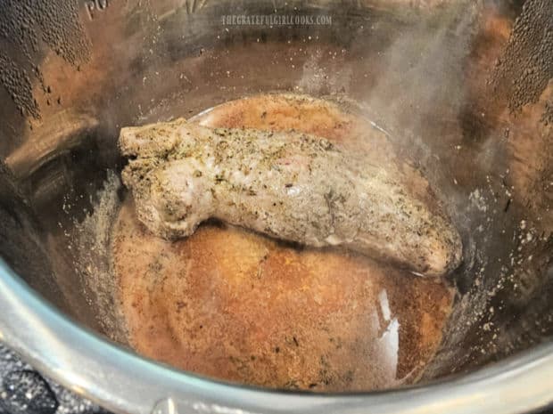 After it's cooked, the tenderloin is removed from the Instant Pot.