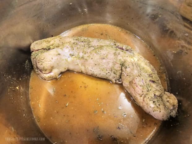 The tenderloin is added to the broth and cooked in the Instant Pot until done.