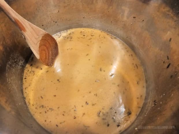 Gravy is cooked until it slightly thickens in the Instant Pot.