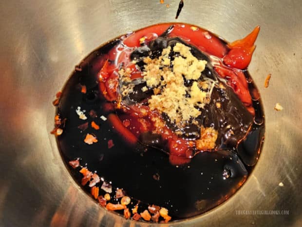 Asian-style BBQ sauce ingredients are measured into a saucepan, then stirred to combine.