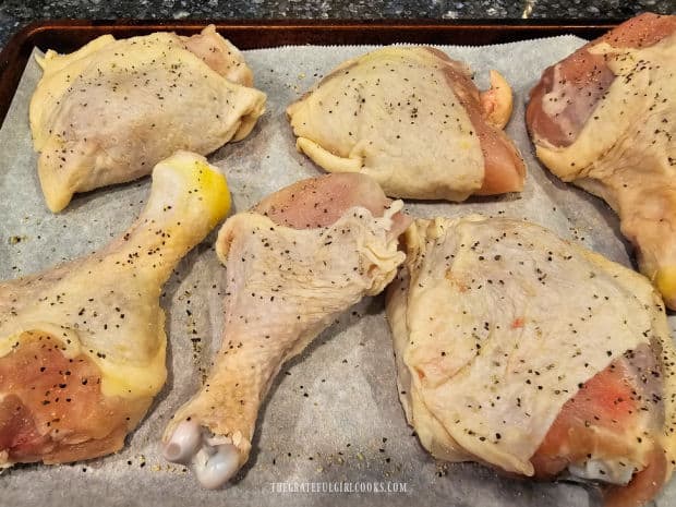 chicken thighs and legs are seasoned with salt, pepper, garlic and onion powder.