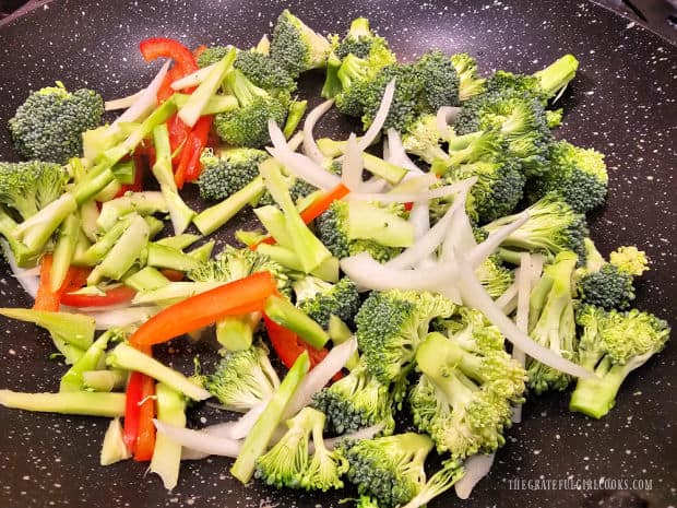 The vegetables are cooked in hot oil in a large skillet.