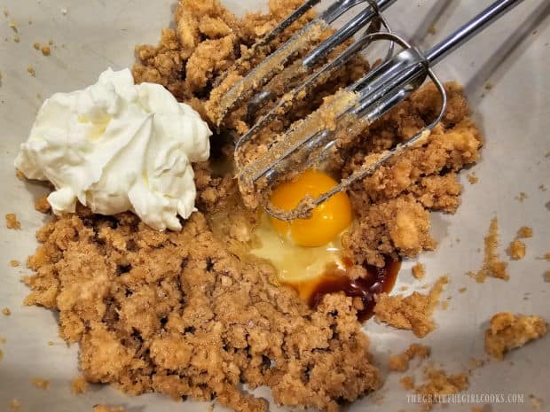 Sour cream, one egg and vanilla extract are mixed into cookie batter until incorporated.