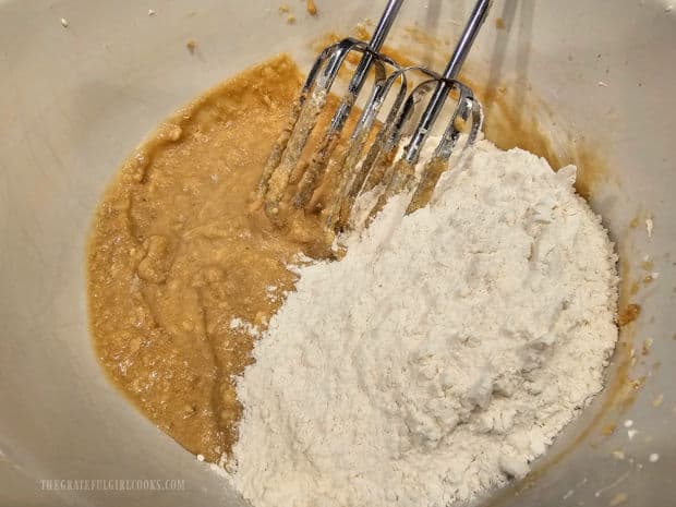 Flour mixture is beaten into the cookie batter only until it is barely combined.