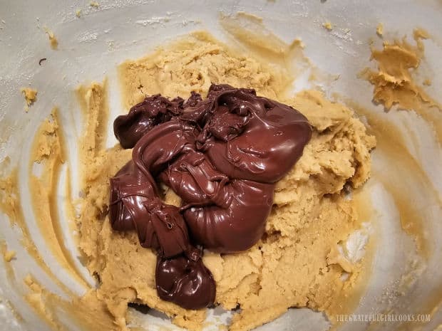 Melted chocolate cools slightly then is added to the cookie dough.