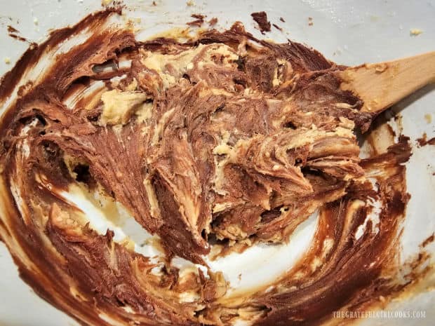 A wooden spoon is used to gently swirl the chocolate through the batter until "marbled".