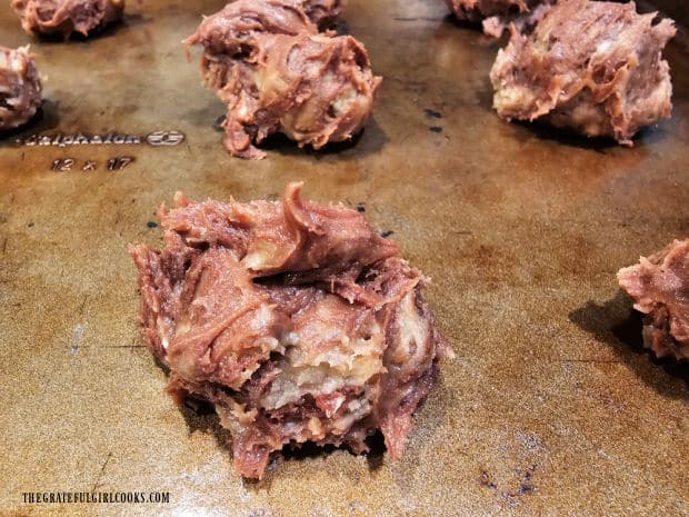 Tablespoons of cookie dough are placed on cookie sheets about 2" apart for baking.