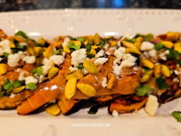 Mediterranean butternut squash is garnished with feta cheese, mint, and toasted pistachios.