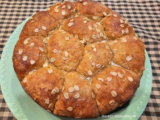 Oatmeal Molasses Dinner Rolls - The Grateful Girl Cooks! A green plate holds the dozen oatmeal molasses dinner rolls, ready to be served.