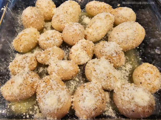 Grated parmesan cheese (fresh or canned) is sprinkled on top of the potatoes.