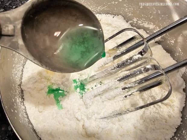 Crème de menthe liqueur is added to the powdered sugar and butter mixture.