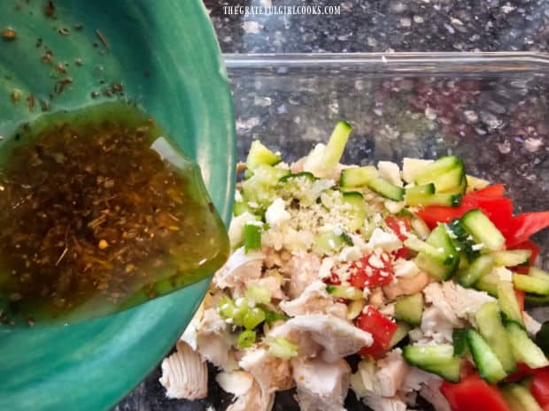 The salad dressing is poured over the chicken mixture and tossed to combine.