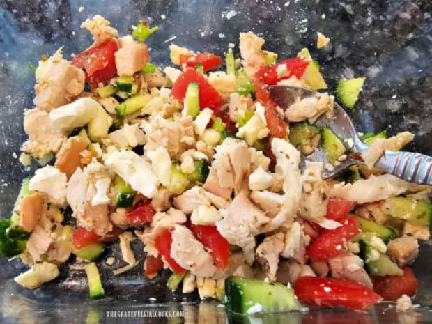 Chicken salad filling is covered with salad dressing and is ready for the tortilla wrap.