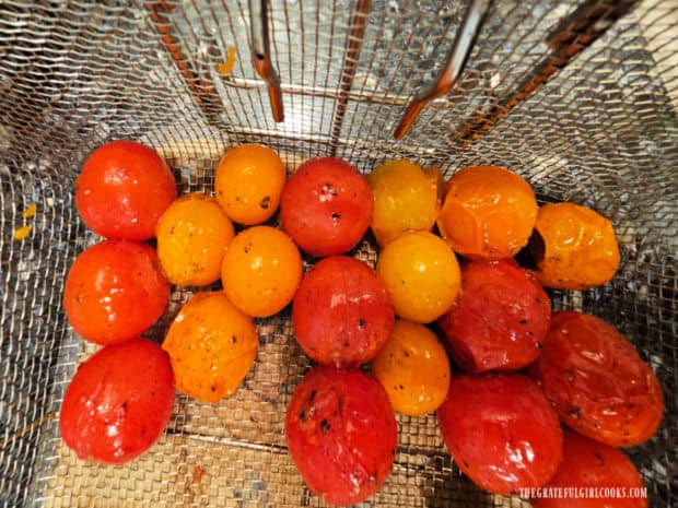 When done, grilled cherry tomatoes are slightly "blistered" on the outside.