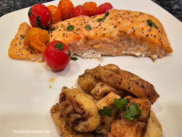A white dinner plate with potato gnocchi and Grilled Plank Salmon and Tomatoes on it.