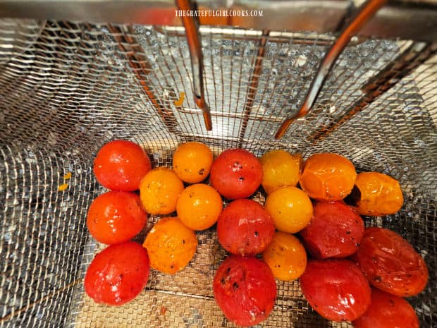 When finished grilling, the cherry tomatoes are blistered on the outside.