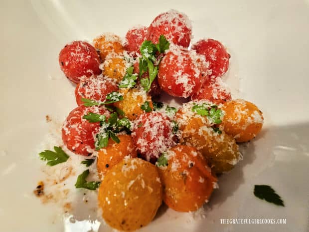 Topped with parmesan and parsley, the grilled tomatoes are ready to serve.