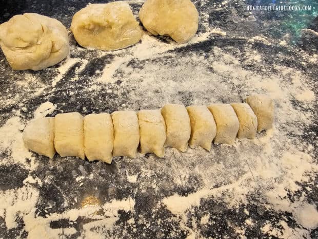 Dough is divided, then each portion is rolled into a log, and sliced into small pieces.