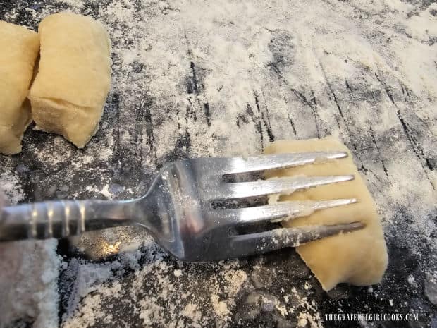 A fork can be used to imprint ridges onto the gnocchi before cooking.