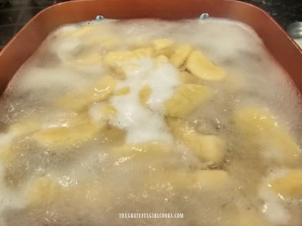 When boiled gnocchi are done cooking, they float to the top in the pan.