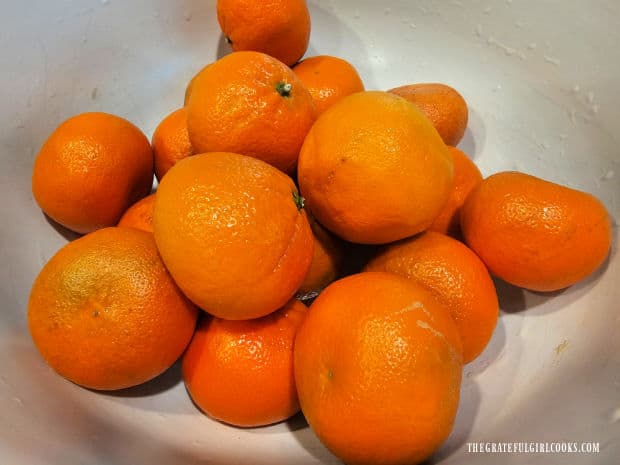 A bowl filled with the mandarin oranges used for canning.