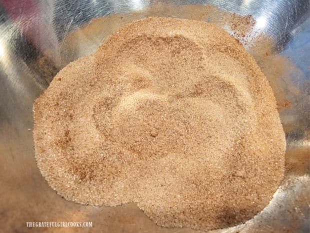 Granulated sugar and ground cinnamon are combined in a small bowl.