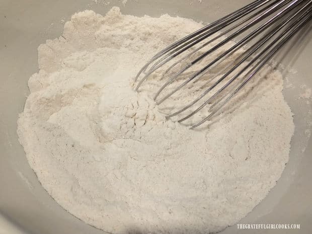 Dry ingredients for the cake batter are whisked together in a medium bowl.