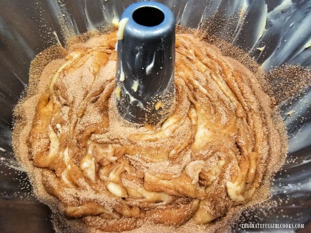 Cinnamon sugar mixture is sprinkled on top of batter, then swirled into the batter.