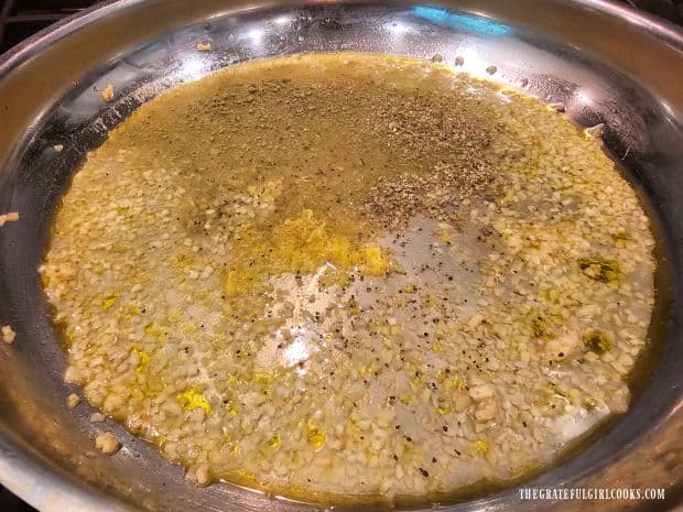 White wine, lemon juice, lemon zest and spices are added to the garlic mixture.