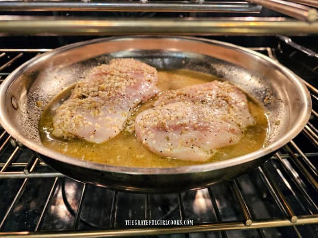 Lemon Garlic Baked Chicken cooks in an oven-safe skillet on the middle rack.