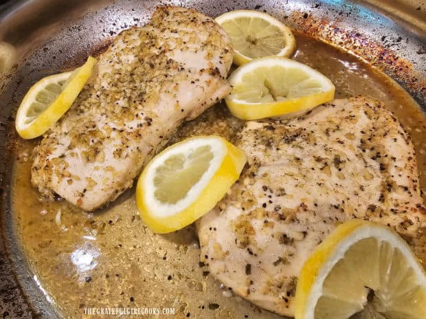 Lemon slices are wedged around the chicken breasts during the baking time.