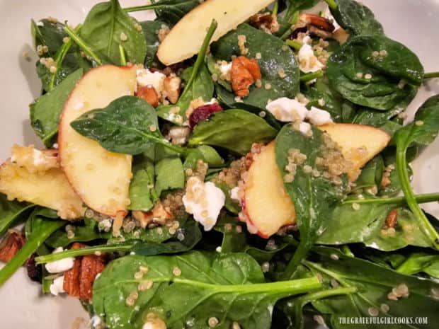 The Spinach Apple Quinoa Salad is ready to serve after the dressing is added.