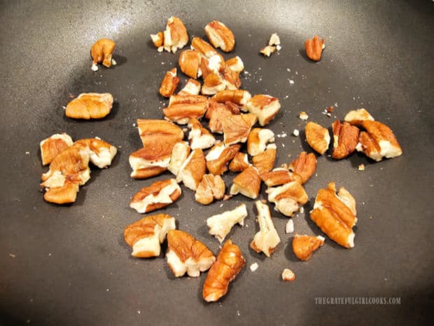 Pecan pieces are lightly "toasted" in a dry skillet until aromatic.