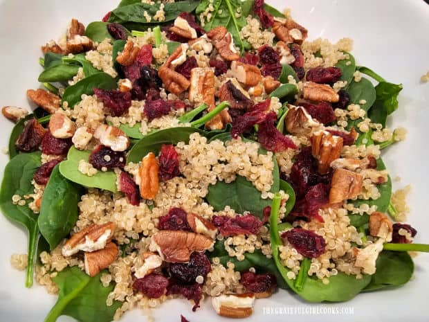 Toasted pecans, dried cranberries are added to the salad.
