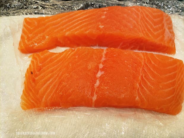 Two thicker salmon fillets are shown as a comparison.
